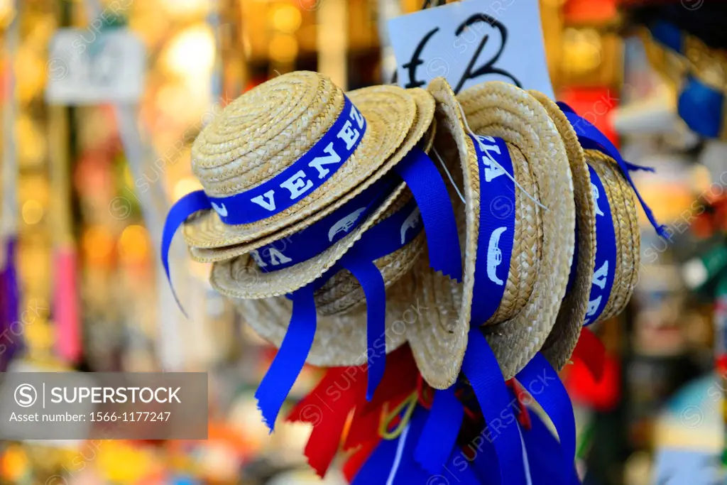 A pile of straw hats,as worn by Venetian Gondoliers,for sale on a stall in Venice,Italy,Europe