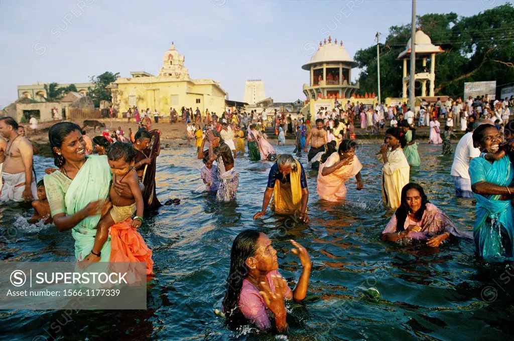 Hindu pilgrims enter the holy waters of Rameswaram to bath in the holy sea