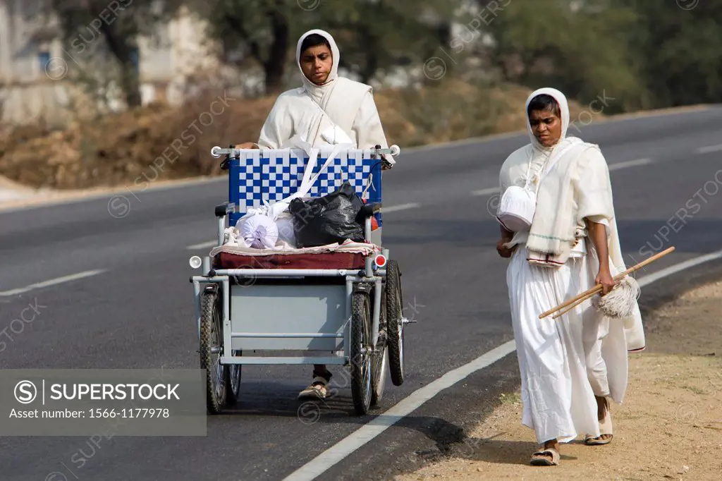Jain women pilgrim saddhu walking from temple to temple near Diver Rajasthan India