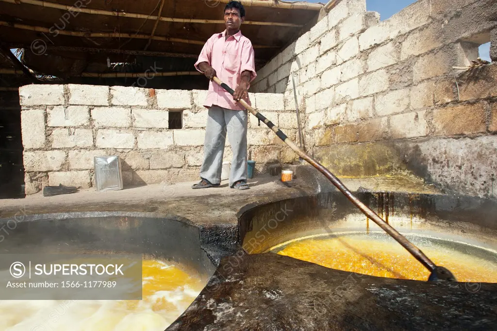 Boiling sugar cane juice to make unrefined sugar jaggery or gur Gujarat India