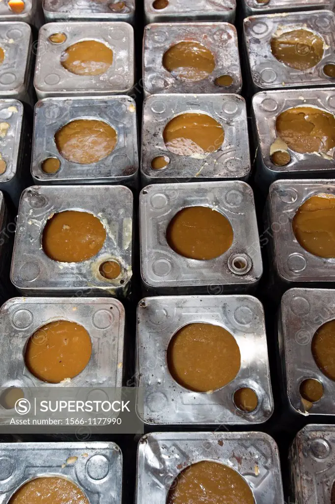 Tins of unrefined brown sugar jaggery or gur Gujarat India