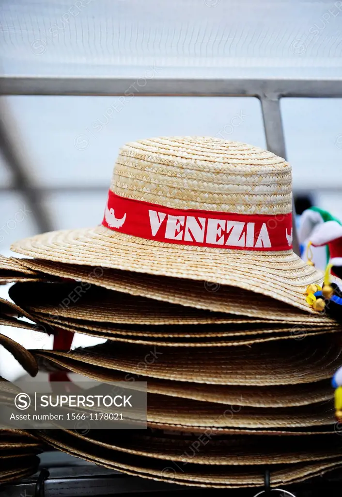 A pile of straw hats,as worn by Venetian Gondoliers,for sale on a stall in Venice,Italy,Europe