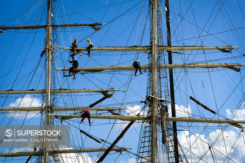 Detail of sailors working on the masts of a vintage yacht,