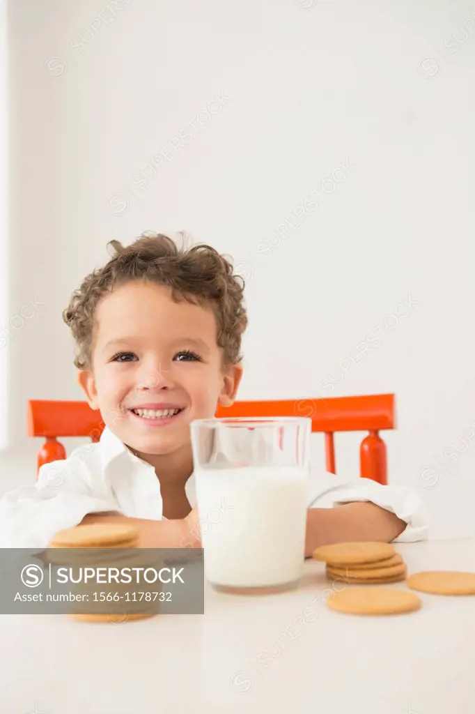 Four year old boy with milk and cookies for breakfast