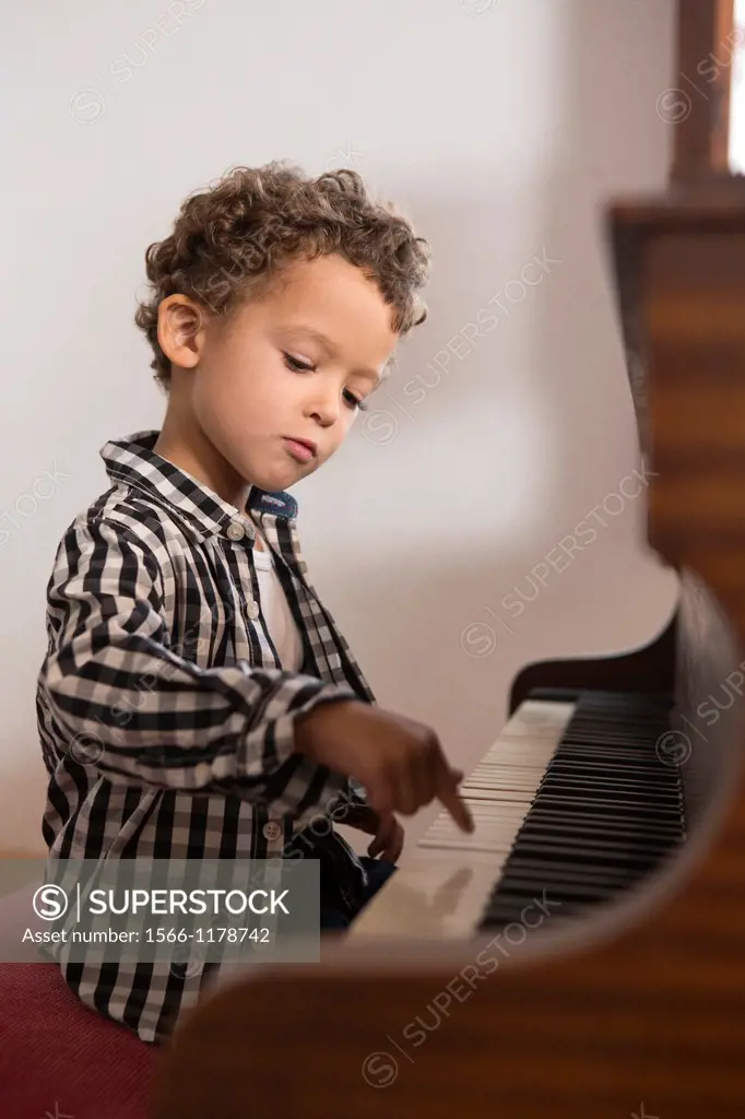 Four year old boy playing the piano