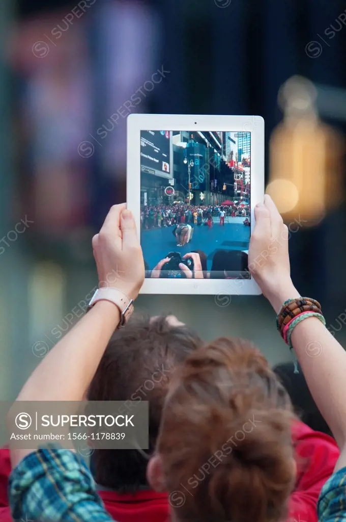 Usa, New York City, Manhattan, Times Square, Man Using iPad for Taking Photographs