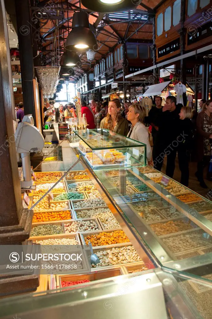 People at dried fruit and nuts shop. San Miguel market, Madrid, Spain.