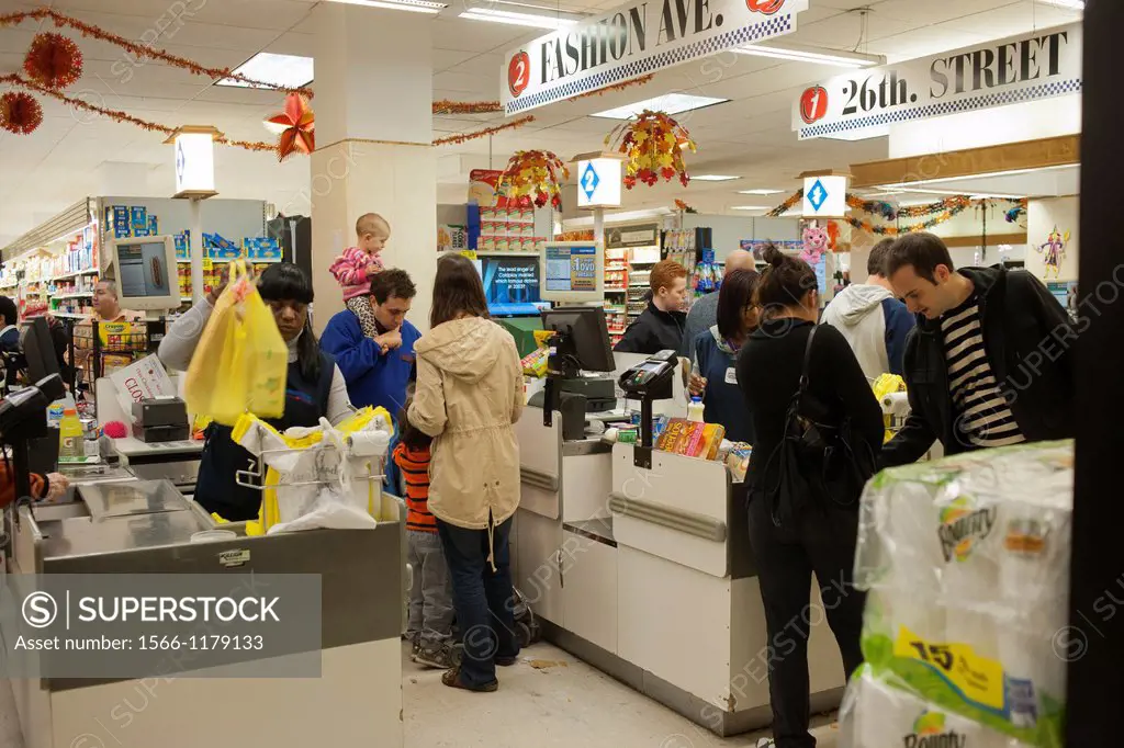 Customers endure long lines because of Hurricane Sandy in a Gristede´s supermarket in the Chelsea neighborhood of New York In advance of the arrival o...