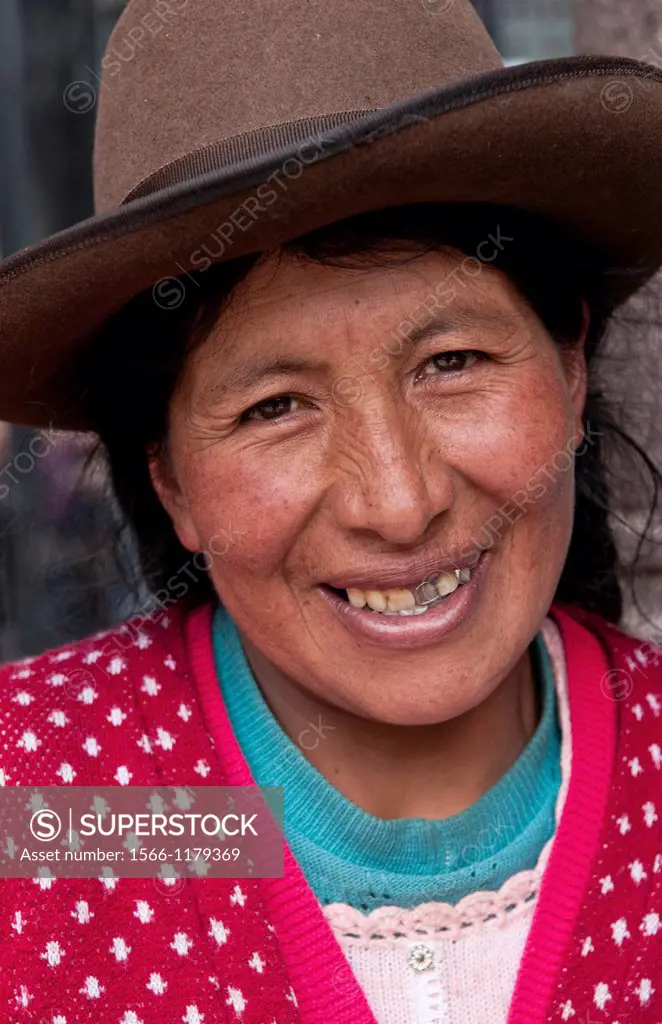 Traditional woman in dress and hat in small town of Pisaq Peru