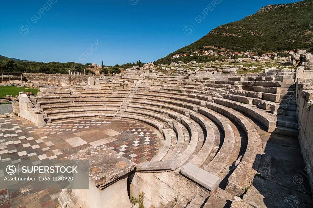 The Ekklesiasterion, assembly hall, at Ancient Messene Ithomi with the modern village of Mavromati in the background, Messinia, Southern Peloponnese, ...