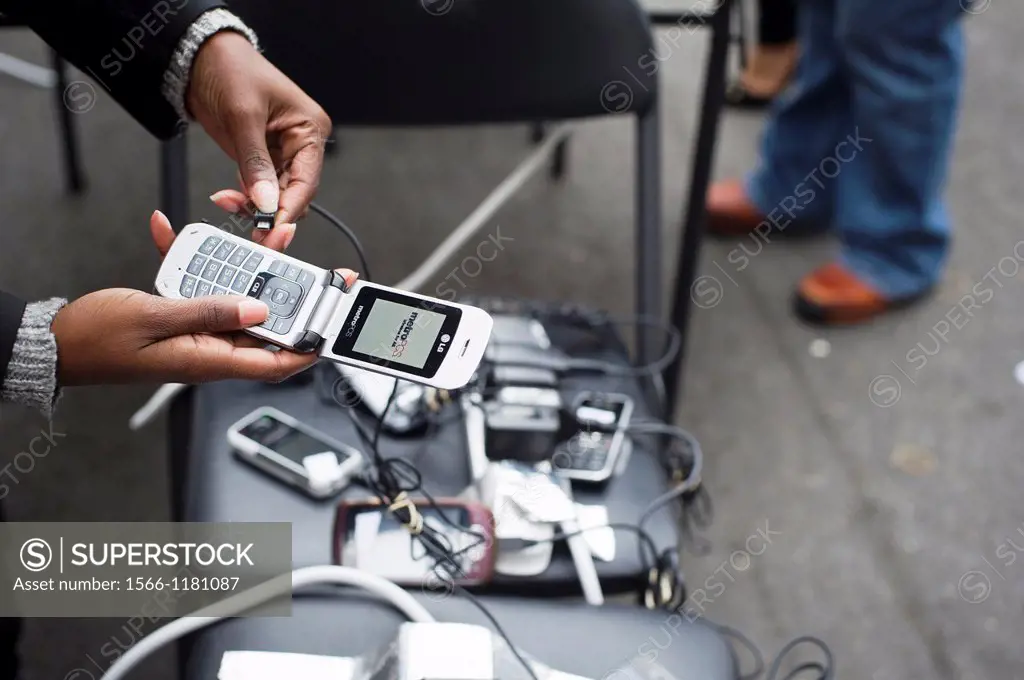 People charging their cell phones in Chinatown in New York Con Edison is estimating electricity will not be restored back to Lower Manhattan for sever...