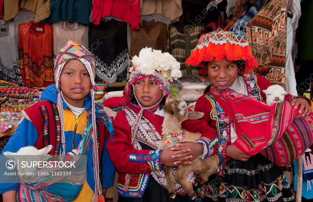 Colorful children in traditional clothes and hats in small town of Pisaq Peru