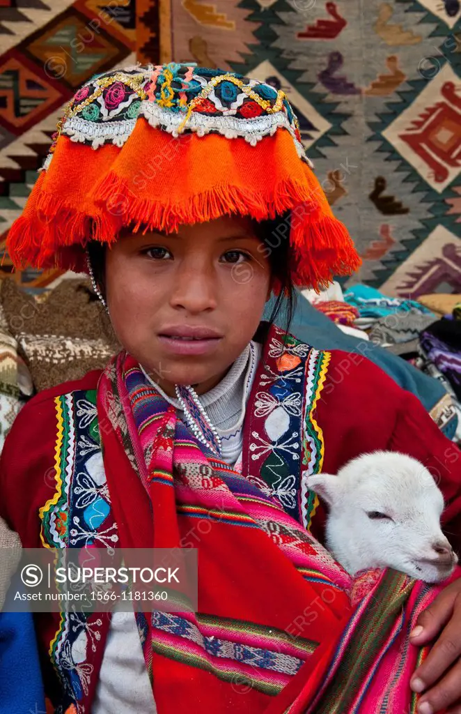 Colorful child in traditional clothes and hats in small town of Pisaq Peru