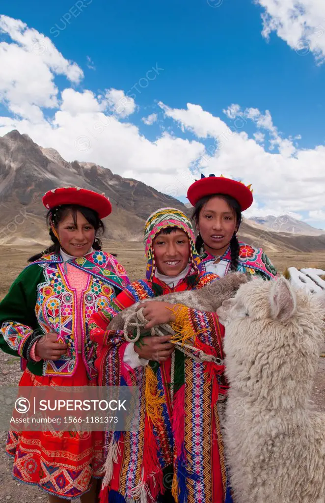 High peak at 13,000 feet of La Raya Peru with young children with llama portrait