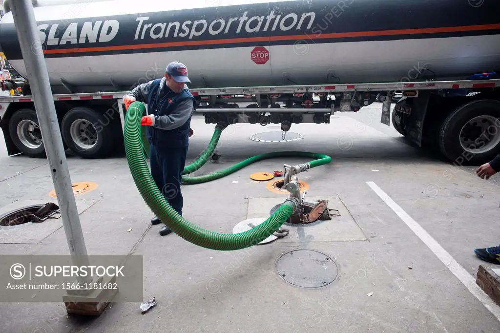 A fuel truck operator delivers gasoline to a Hess gas station in the Clinton neighborhood of Manhattan in New York Motorists and people with gas cans ...