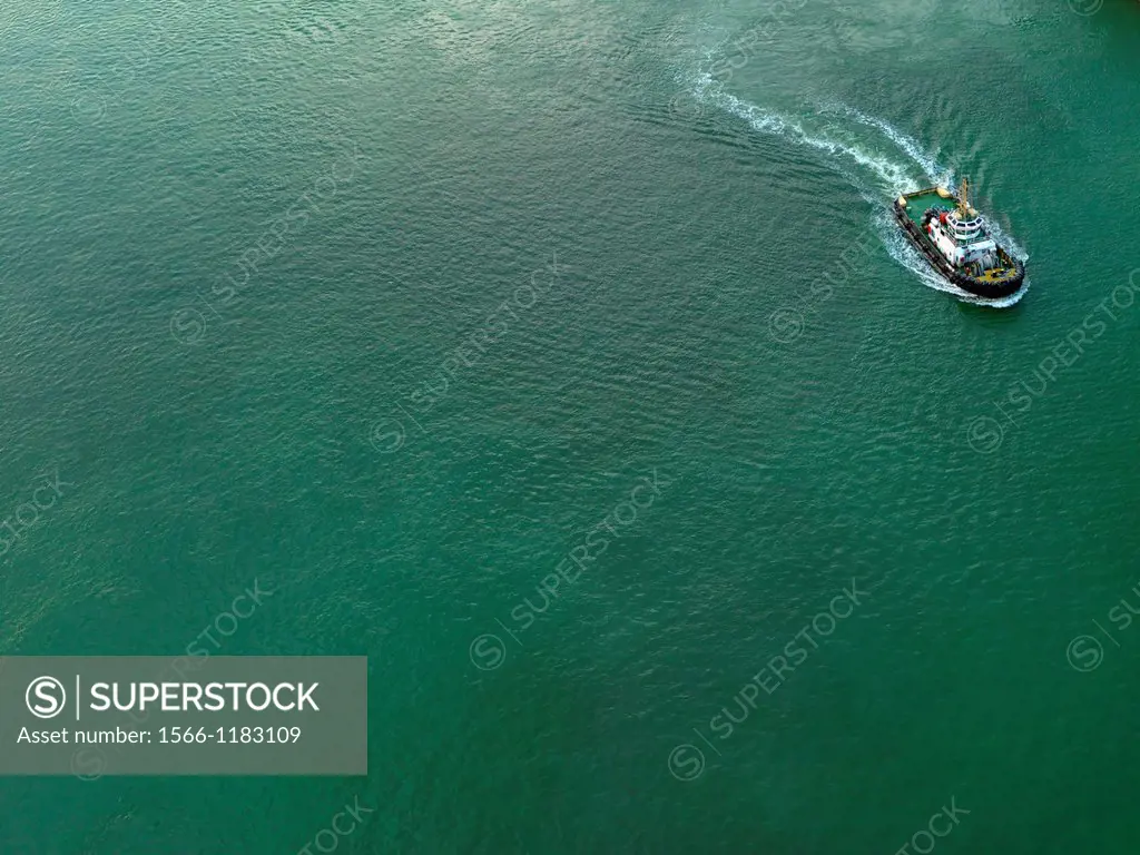 A tug boat moving through a harbor