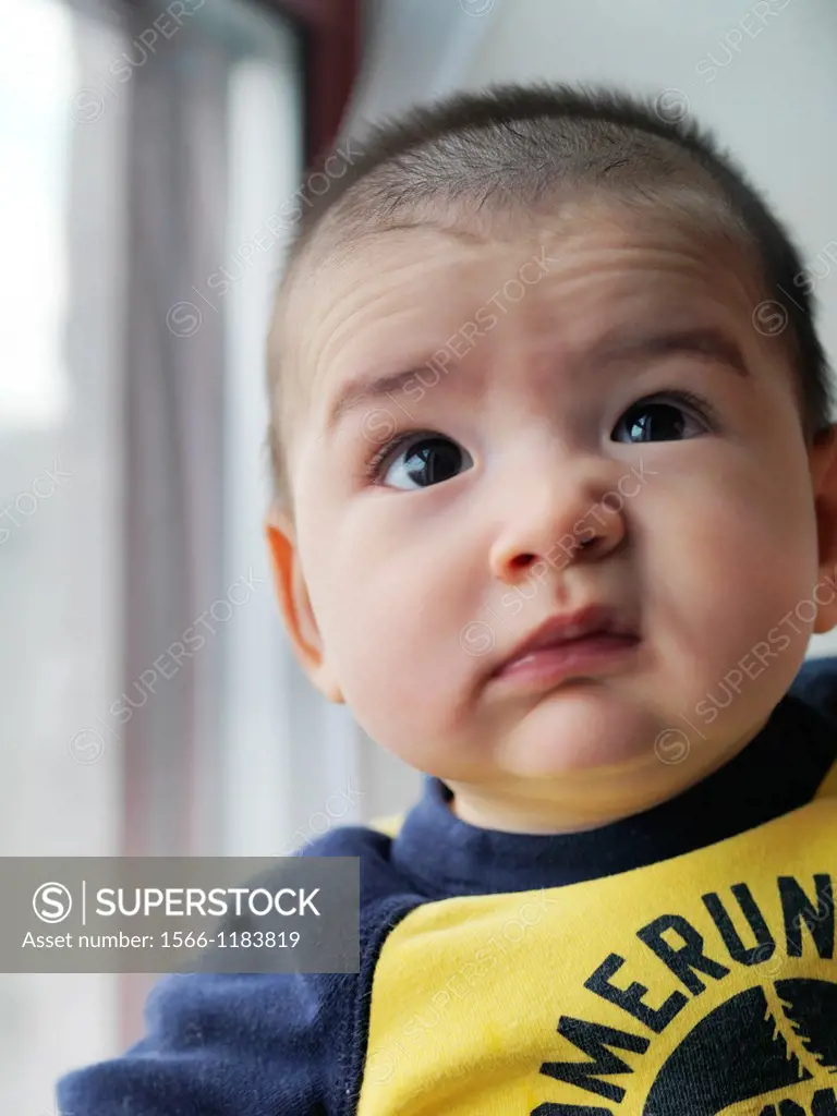 A multi ethnic baby boy making various faces and gestures