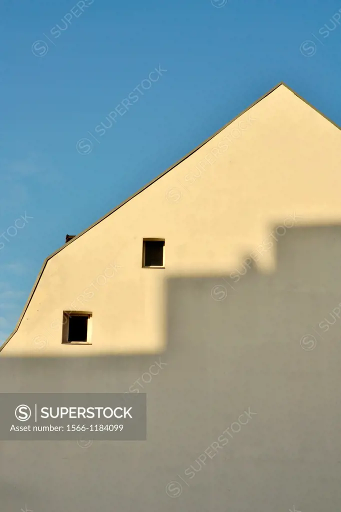 rooftops of houses in the Ceramique neighbourhood of Maastricht with shadows on the building