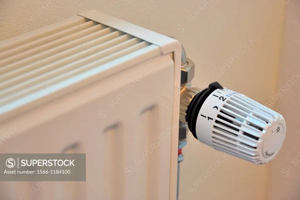 white radiator with dial set to nighttime setting to conserve energy