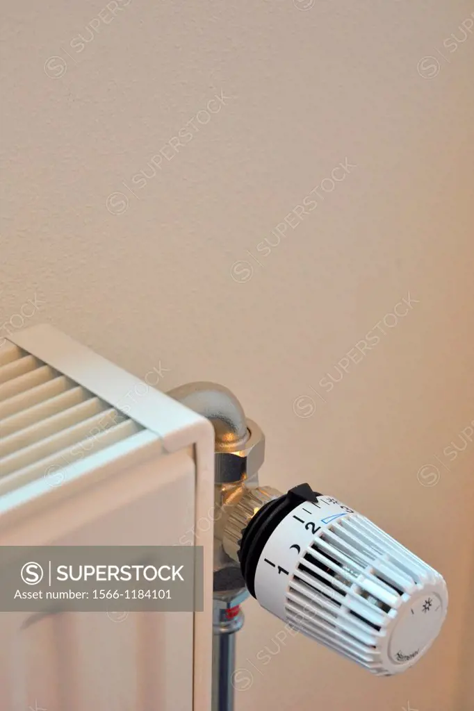 white radiator with dial set to nighttime setting to conserve energy