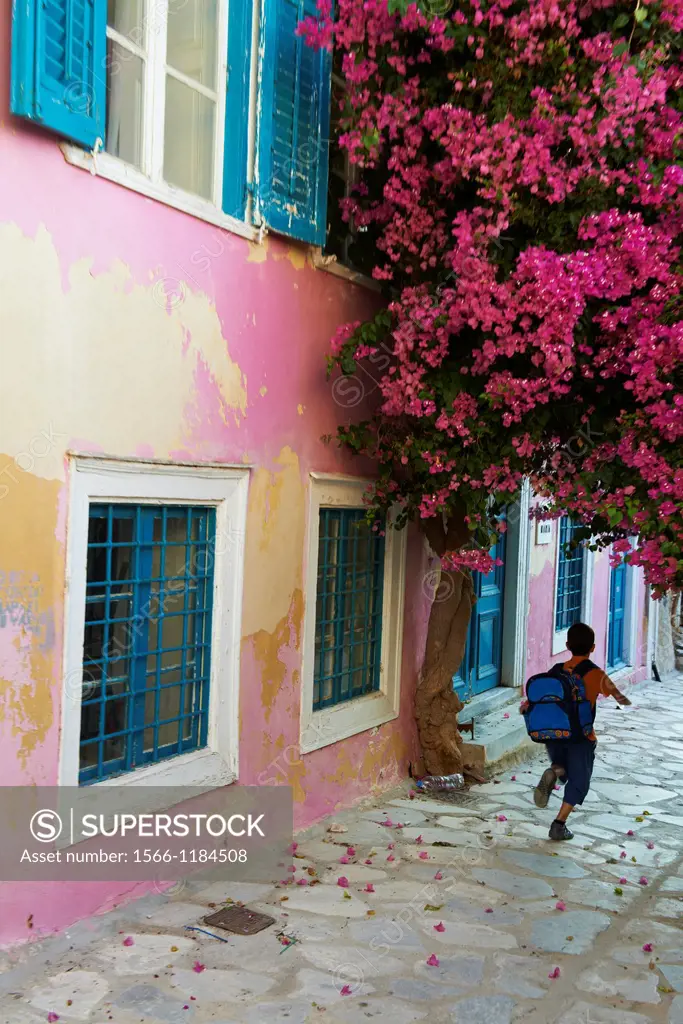 Greece, Cyclades Islands, Syros Island, Ermoupoli, Boy Running Down Old Town Alley