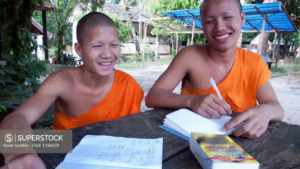 Young monk practises writing temple old quarter Luang Prabang Laos PDR
