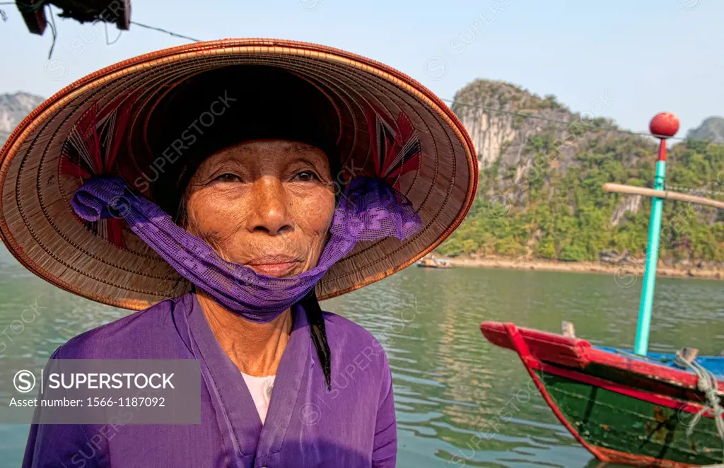 Vietnam, Halong Bay, Old woman in purple in fishing village