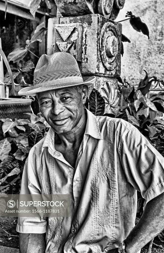 Portrait of attractive man in straw hat in downtown Havana Cuba