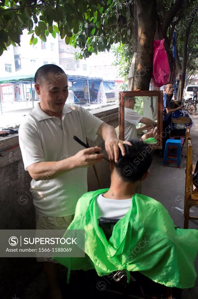 Street barbers at outskirt of Guangzhou, China.