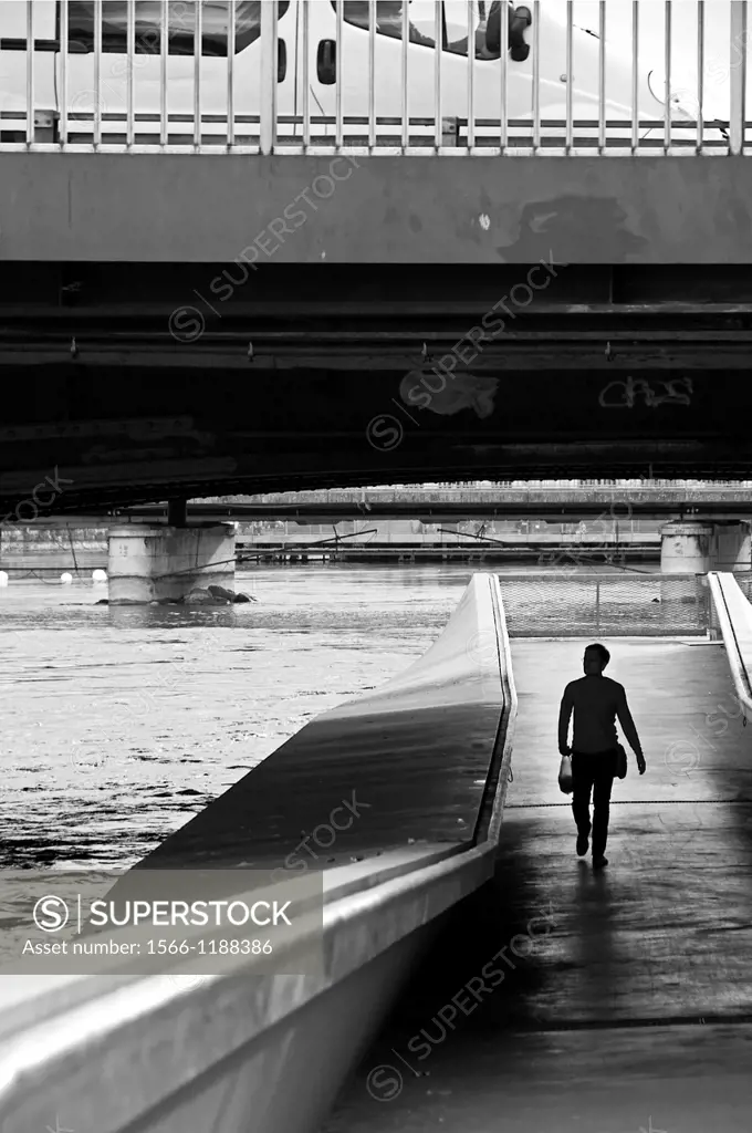 man walking under Mt Blanc bridge on Rhone river, car on the bridge, Geneva, Switzerland