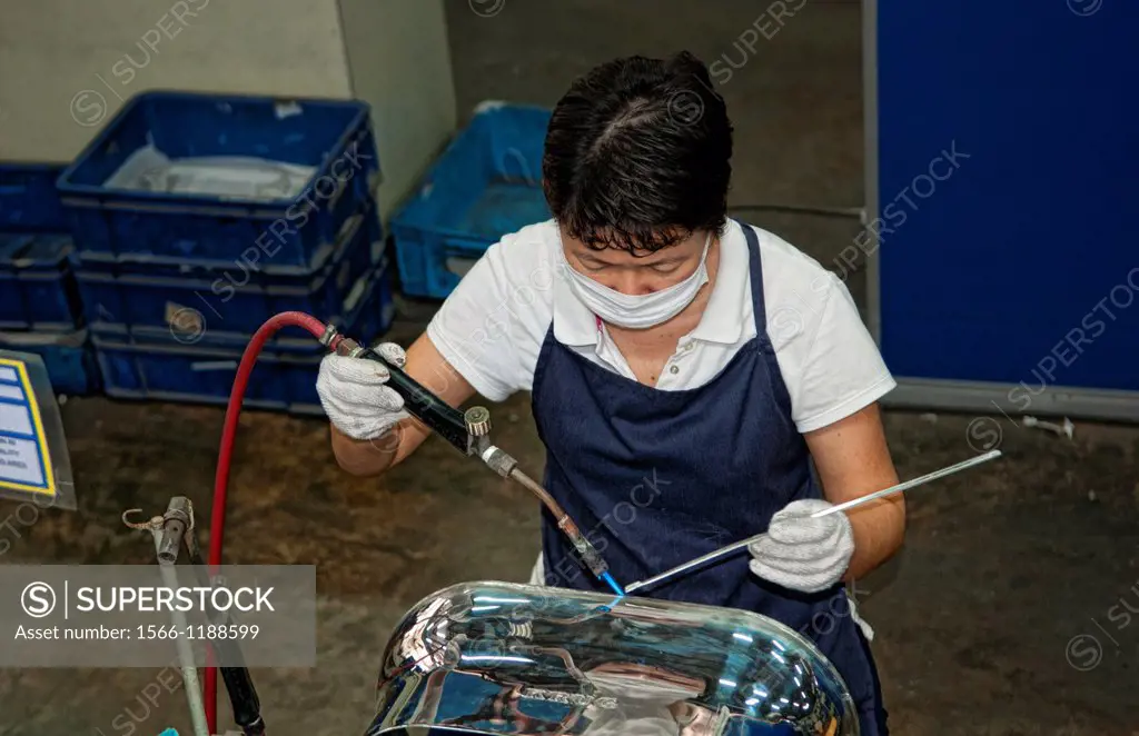 Worker welding in Pewter Factory called Royal Selangor in Kuala Lumpur Malaysia Asia