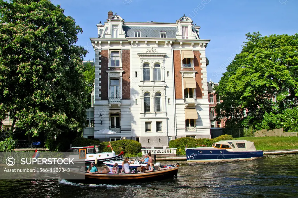 Boats in front of an old town house on the Stadhouderskade, Amsterdam, Holland