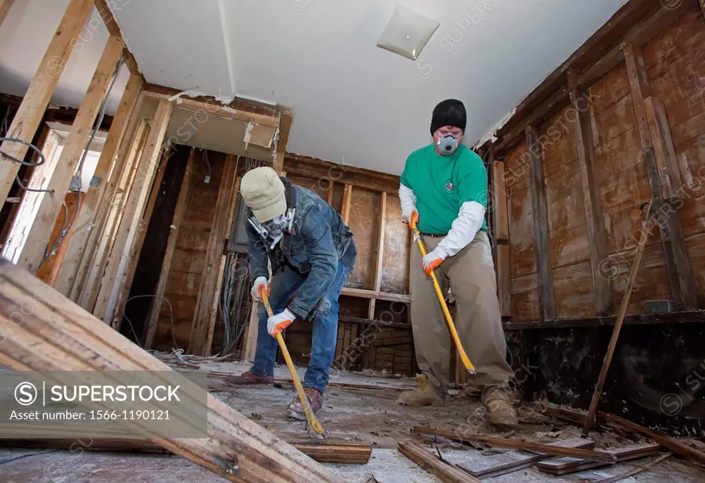 New York, New York - Volunteers on Staten Island help with the recovery from Hurricane Sandy, removing drywall and flooring from the flooded house of ...