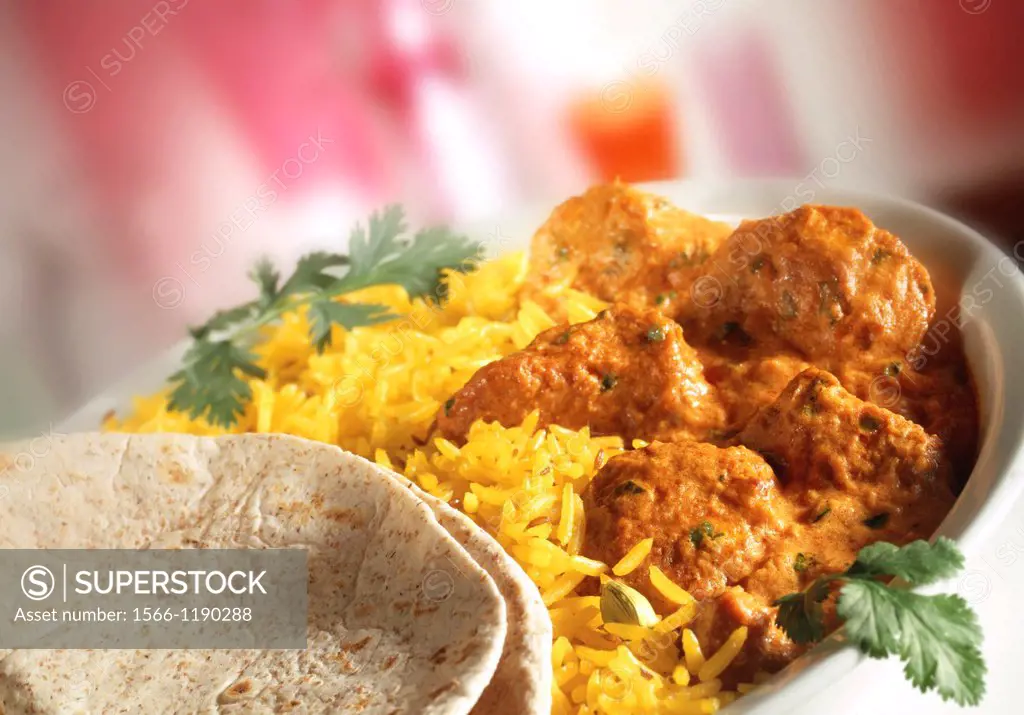 Chicken Tikka Masala - Pilau rice & naan bread in white dish with red background