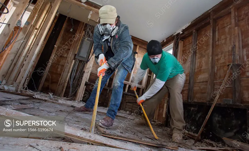 New York, New York - Volunteers on Staten Island help with the recovery from Hurricane Sandy, removing drywall and flooring from the flooded house of ...
