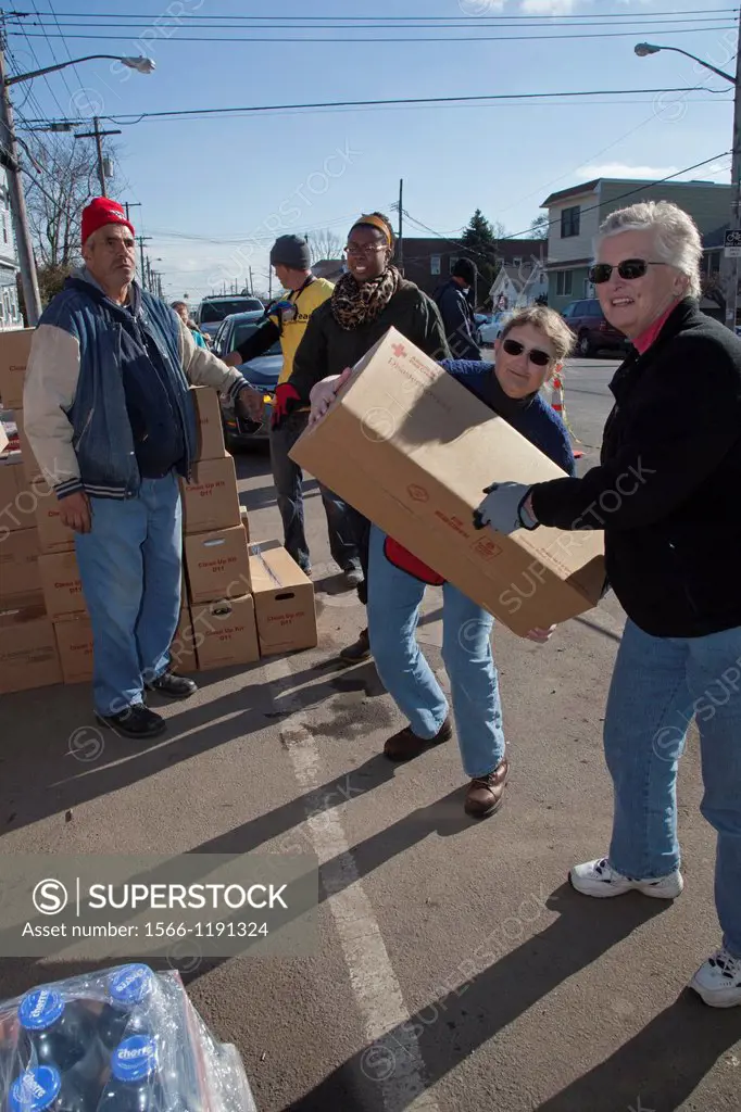 New York, New York - Volunteers on Staten Island help with the recovery from Hurricane Sandy, unloading supplies on a street corner for neighborhood r...