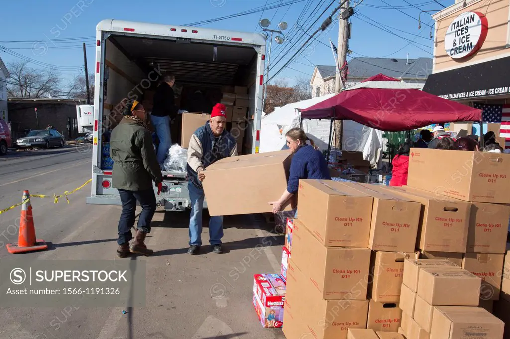 New York, New York - Volunteers on Staten Island help with the recovery from Hurricane Sandy, unloading supplies on a street corner for neighborhood r...