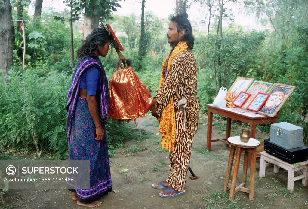 Traditional hindu healer curing patients by invoking the hindu god Shiva. Kathmandu valley, Nepal.