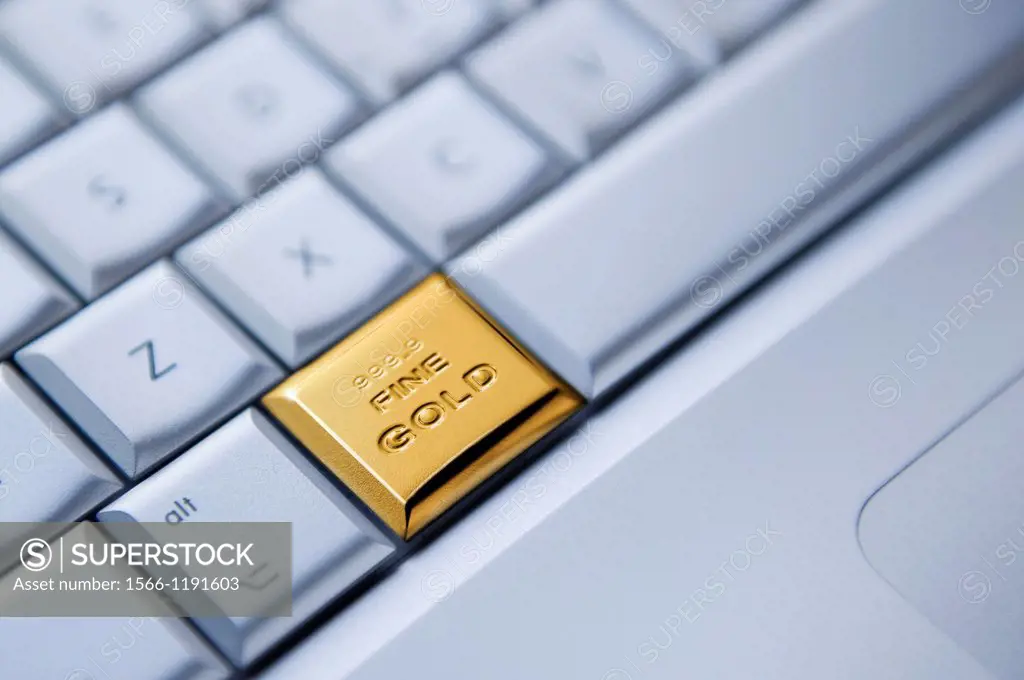Detail of a keyboard with one key as a solid gold bar