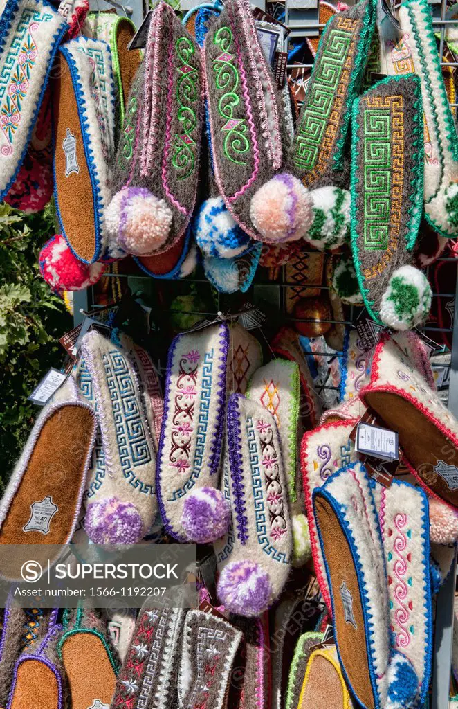 Display of Greek souvenirs bshoes on rack in downtown shopping area of Athens Greece in Plaka