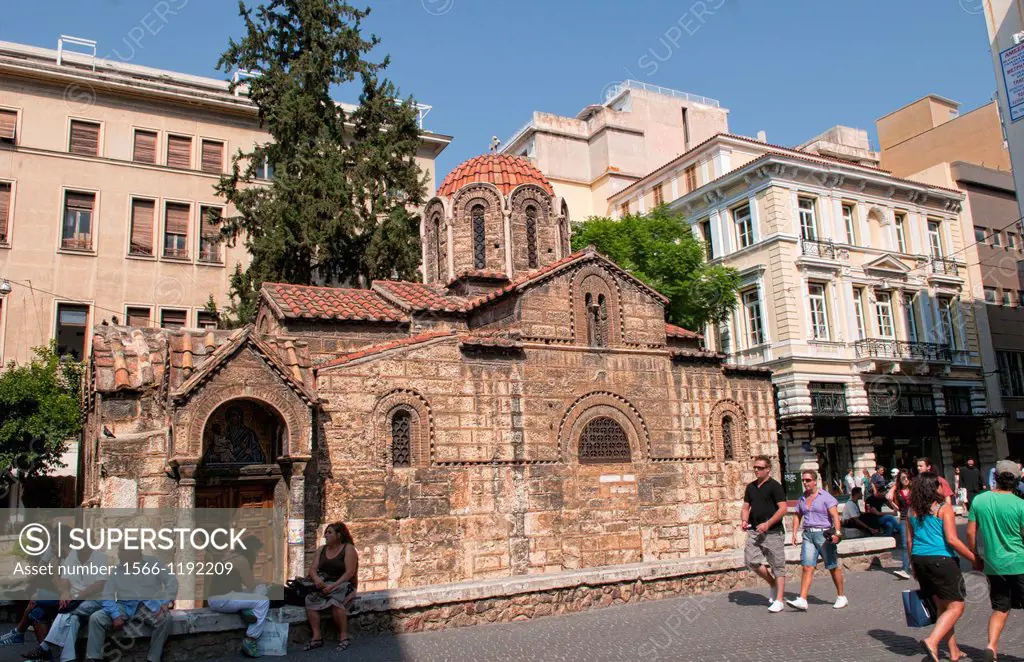 Busy downtown street in Plaka area of Athens Greece with shopping and stores and 11th Century Byzantine Cathedral