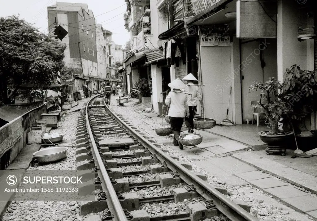 Daily life by the train tracks in Hanoi in Vietnam in Southeast Asia Far East