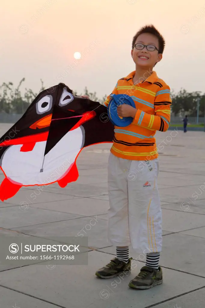 China, Shanghai, Pudong Xin District, Oriental Sports Center, Asian, boy, delta kite flyer, flying, reel, line, hand wheel, hobby,