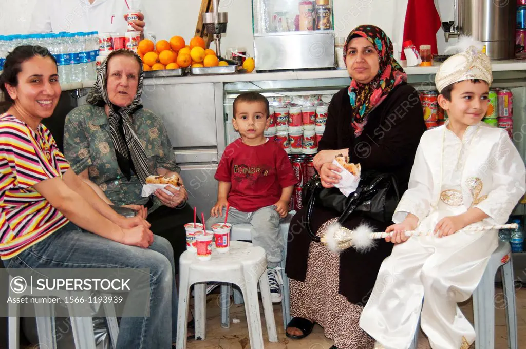 A Turkish family gathers for refreshments in Istanbul, on the day of the eldest son´s circumcision ceremony