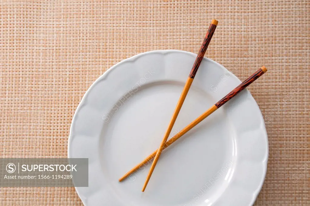 Chinese chopsticks on empty plate