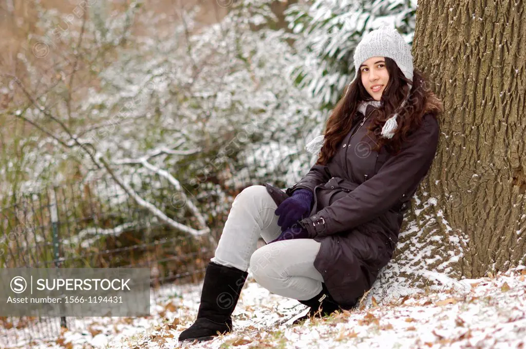 Portait of a teenager in a snowy day the park
