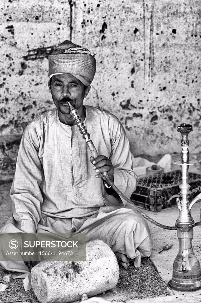 Man smoking water pipe in Cairo Egypt