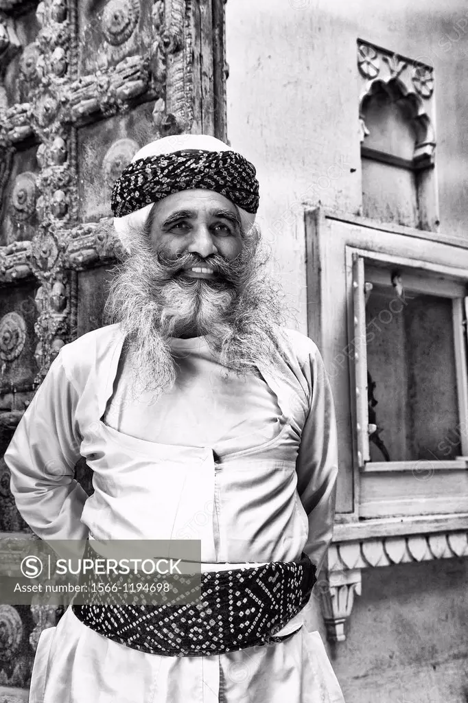 Jodhpur at Fort Mehrangarh in Rajasthan India a great image of bearded character man guard in doorway of Fort Palace in costume