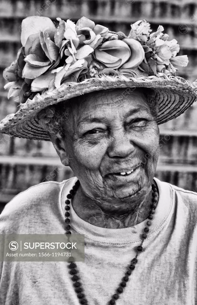 Portrait of older woman smiling in straw hat in Havana Habana Cuba