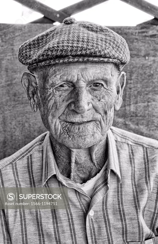Old man 85 years old in Syros Greece island with hat and portrait smile